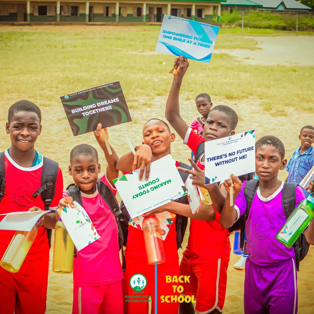 Children holding 'Building Dreams Together' signs