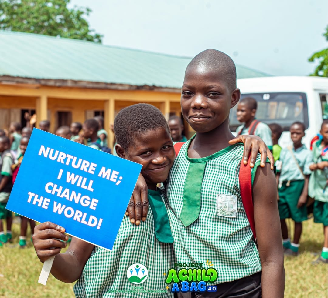 Children holding 'Nurture Me; I Will Change The World' sign
